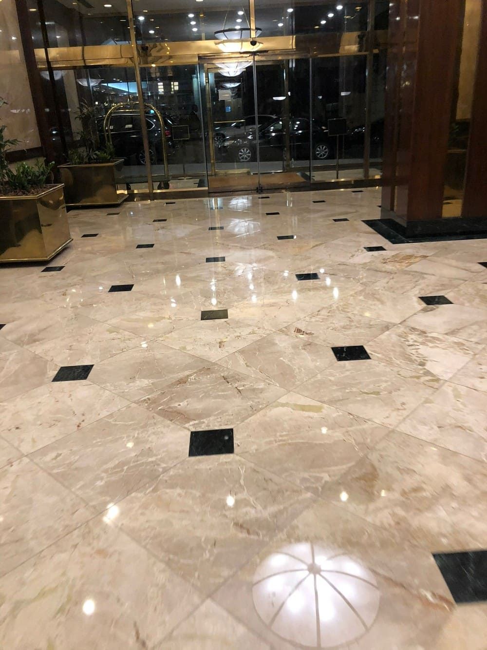 Polished marble lobby floor with black inset tiles